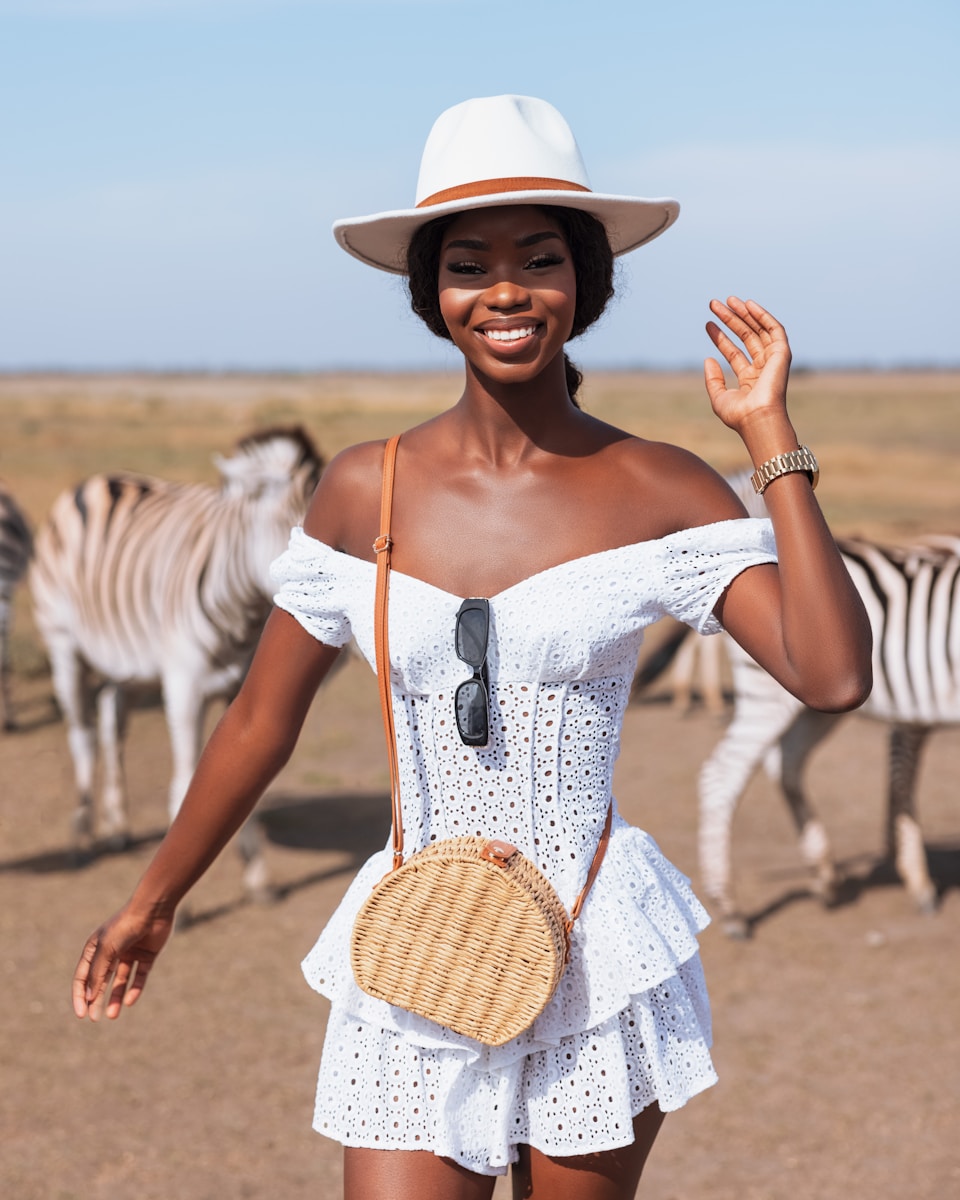a woman wearing a white dress and a straw hat